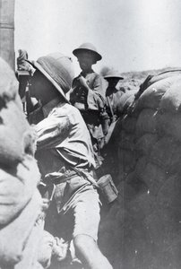 Soldier looking through a trench periscope, from an album compiled by Lt. Kindom
